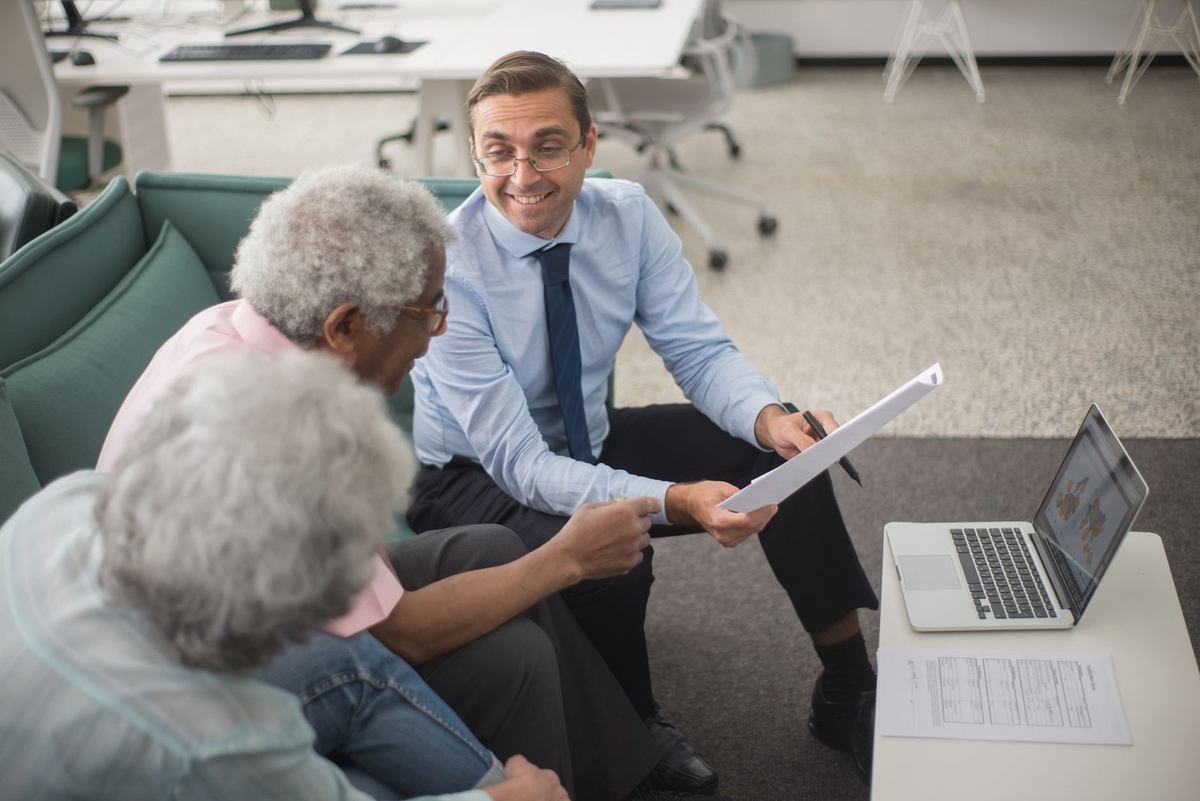 Professionnels en réunion avec un ordinateur et des documents Professionnels en réunion avec un ordinateur et des documents